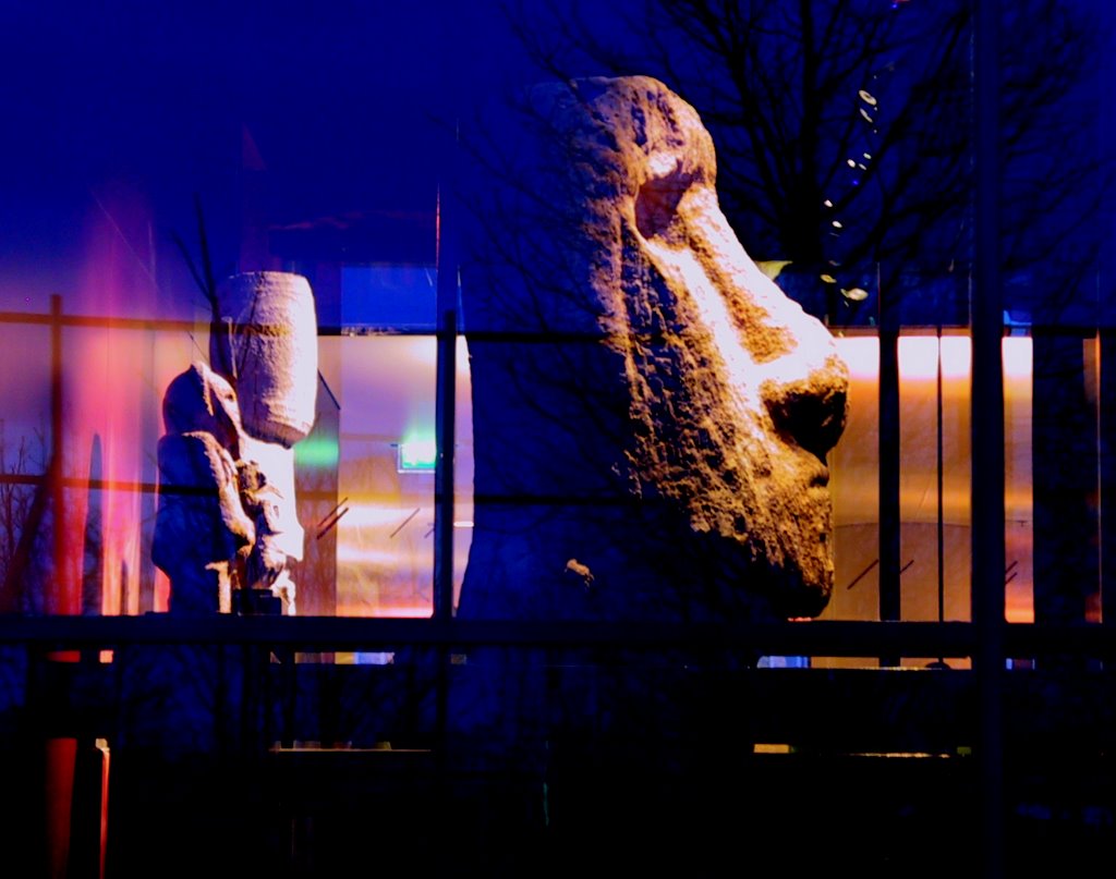 The Musée du quai Branly at night, its garden façade glowing through the trees