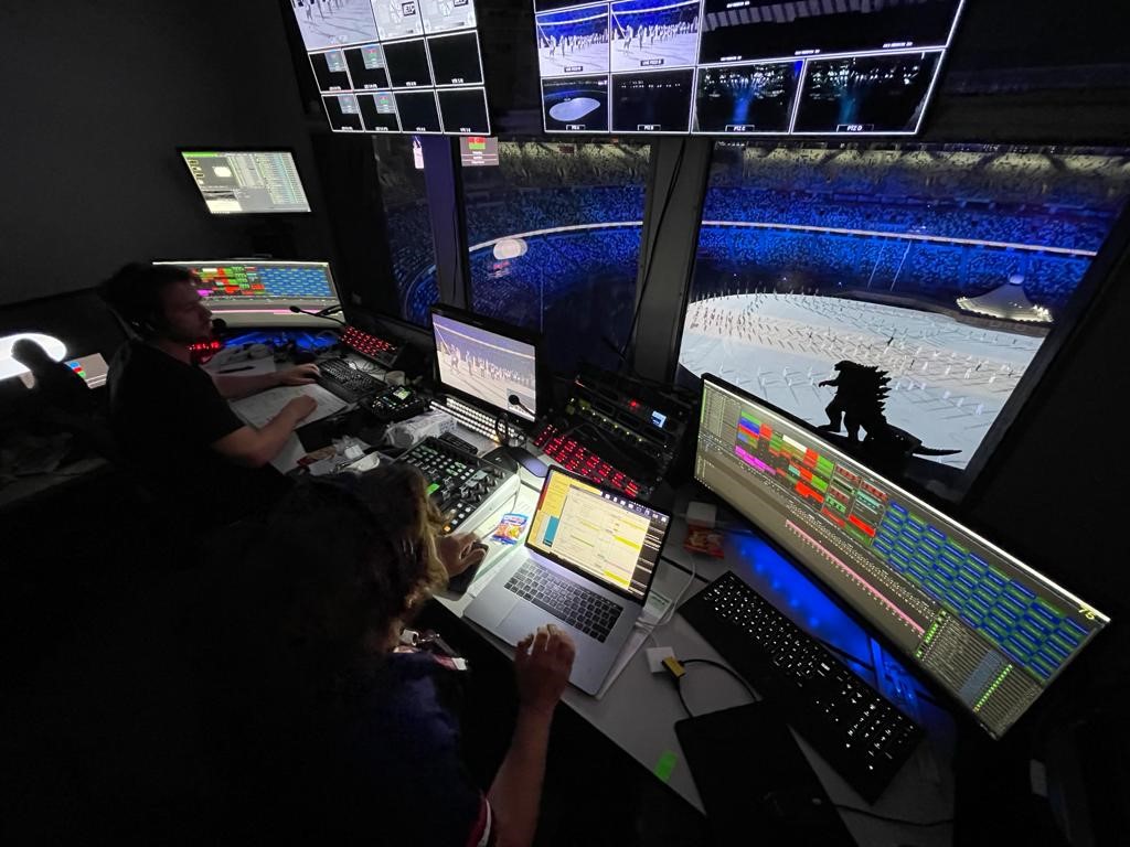 An Onlyview operator at a control console, a star-field projection on the wall behind